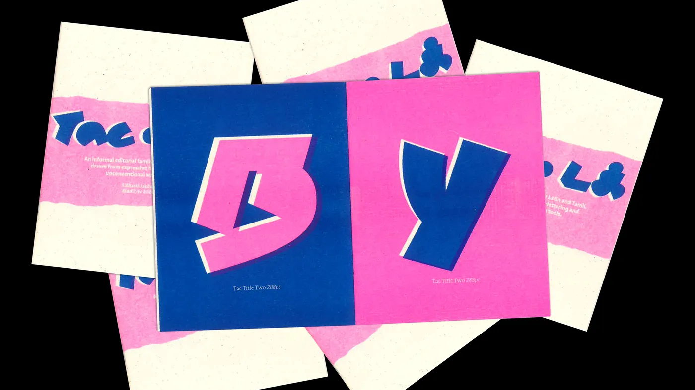 Giant pink and blue Tamil letterforms from the Tac family